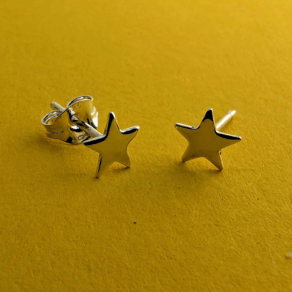 Tiny sterling silver star stud earrings with solid silver posts and butterfly backs