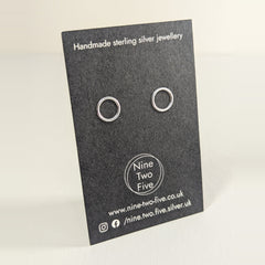 'Eclipse' Sterling Silver Tiny Circle Stud Earring on the Nine Two Five earring card, view 2