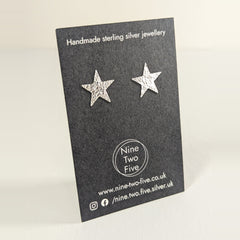 'Fallen Star' Sterling Silver Textured Medium Star Stud Earring on the Nine Two Five earring card, view 2