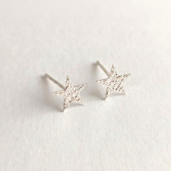 'Fallen Star' Sterling Silver Small Hammered Star Stud Earring, view 1