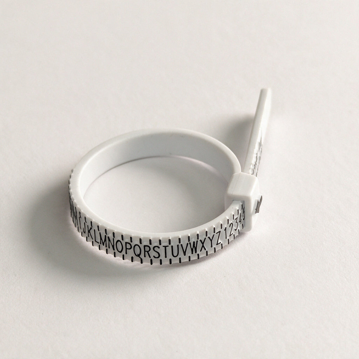 Adjustable ring sizer formed into a ring, UK sizes A to Z